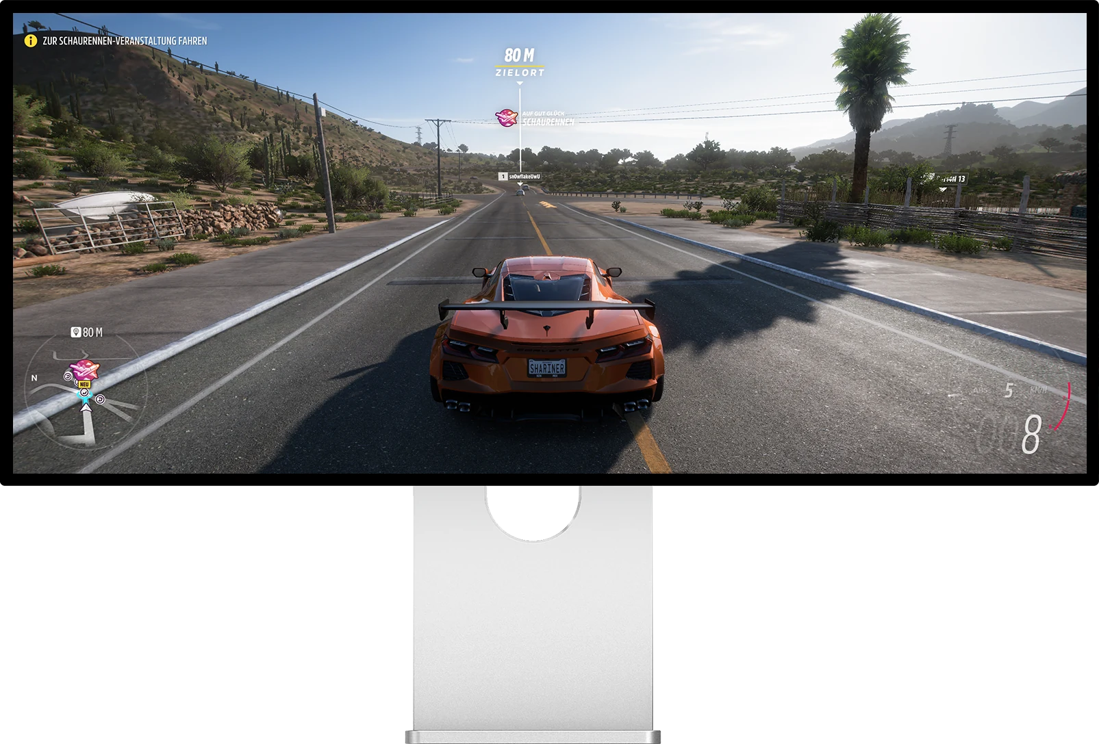 Kuycon W34KB showing a racing game across the full 21:9 canvas | Kuycon