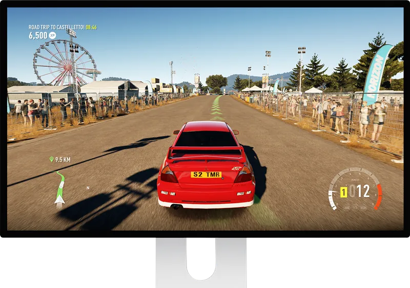 Kuycon P27D monitor on its stand showing a rally game: a red car on a dirt track lined with spectators
